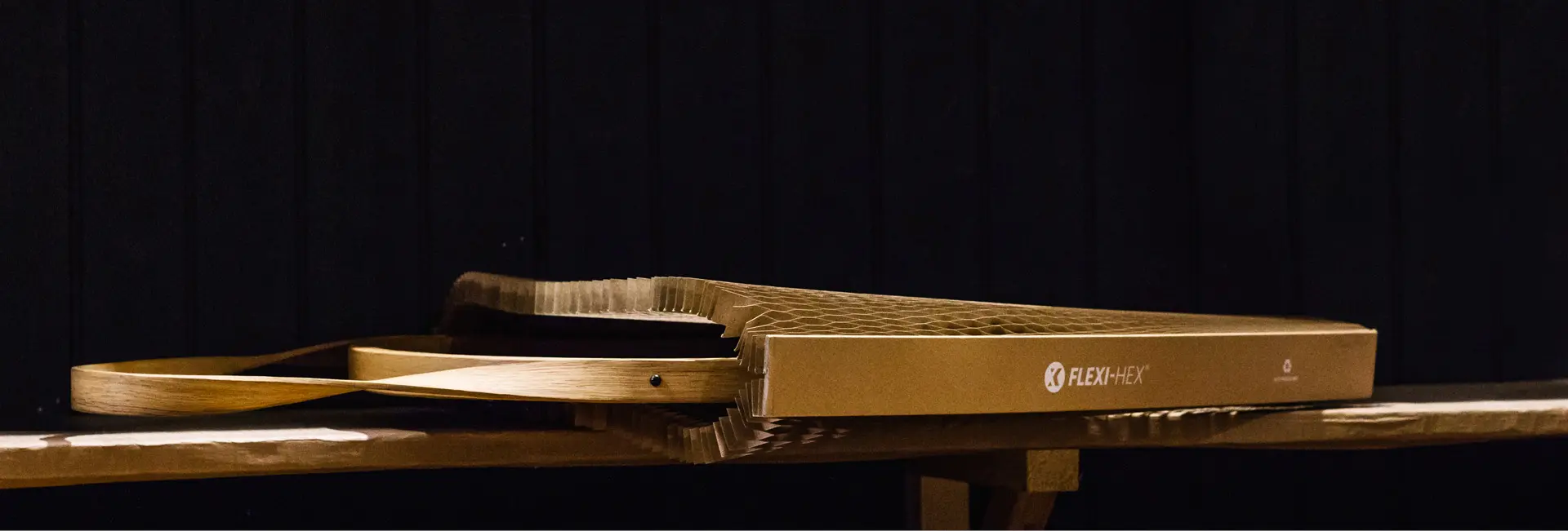 A dark image in a workshop showing a Flexi-Hex sleeve protecting a mirror