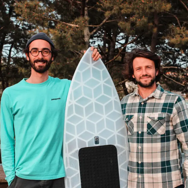 Two surfers, Wyve Founders, Léo and Sylvain, with their 3D printed, custom-made, eco-responsible, durable surfboard with a unique transparent design.