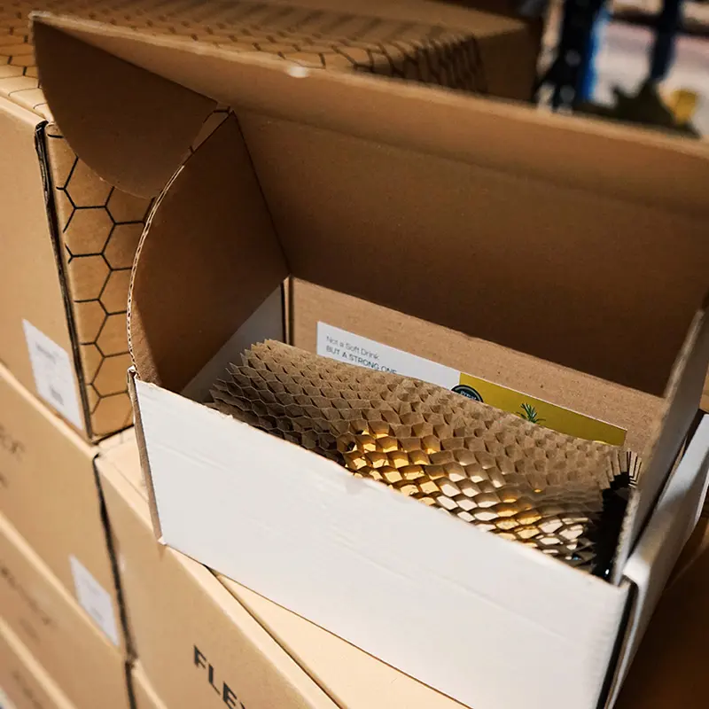 Flexi-Hex protecting a bottle in a box ready for mail order