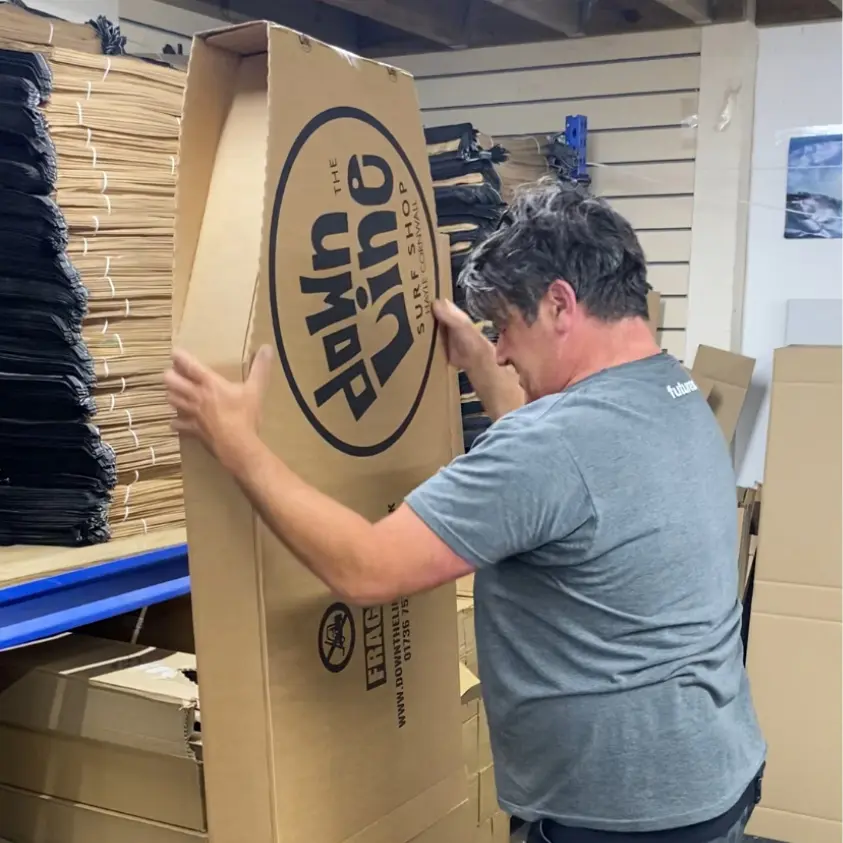 A printed Flexi-Hex surfboard box being packed in a surfshop ready for delivery worldwide